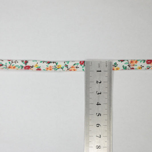 Floral ribbon with a ruler for measurement on a white background
