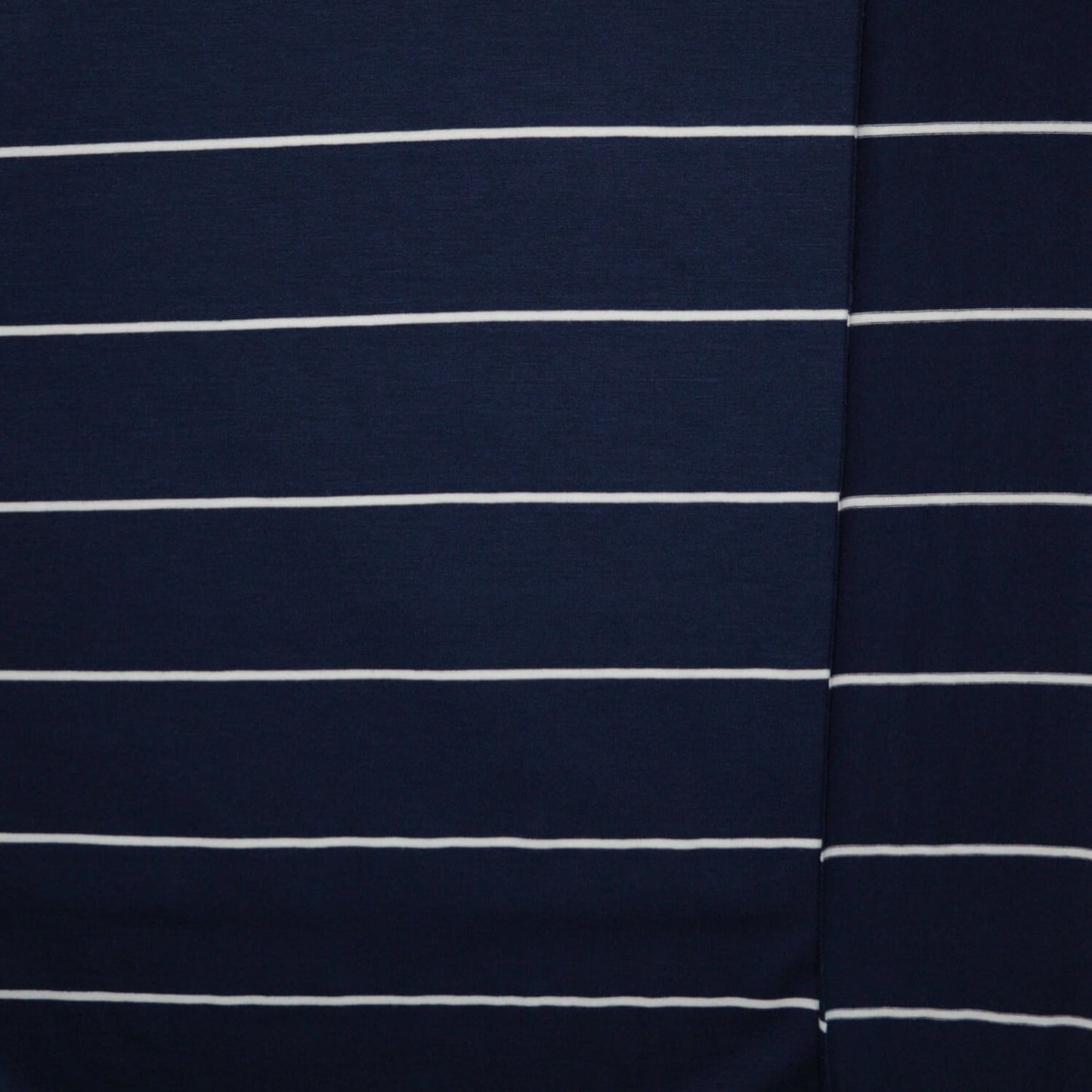 Close-up of navy blue fabric with white stripes
