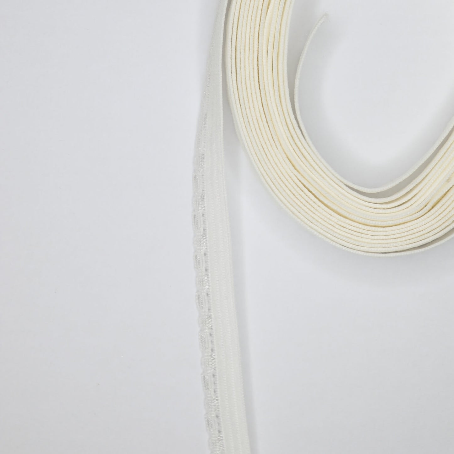 A roll of off-white pico elastic, 10mm wide and 3 meters long, typically used in sewing and crafting projects.