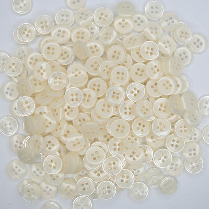 A collection of cream pearlescent buttons with a 13mm diameter, displayed in a pack.