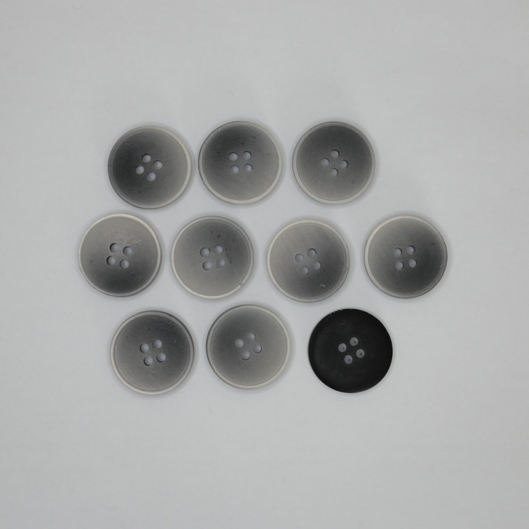 Ten round four-hole buttons arranged in a grid on a plain light background, with eight translucent gray buttons and one solid black button back.