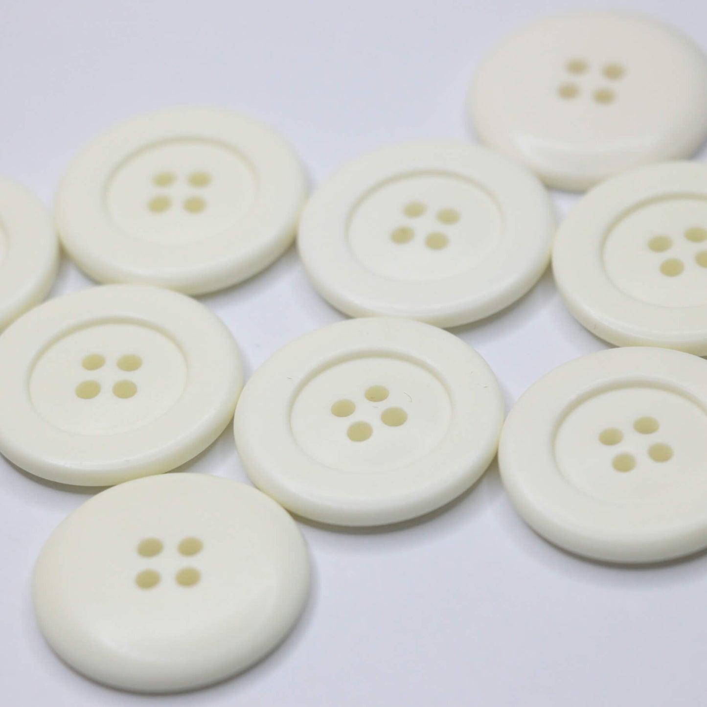 27mm Off-White Plastic 4H Buttons 10pk