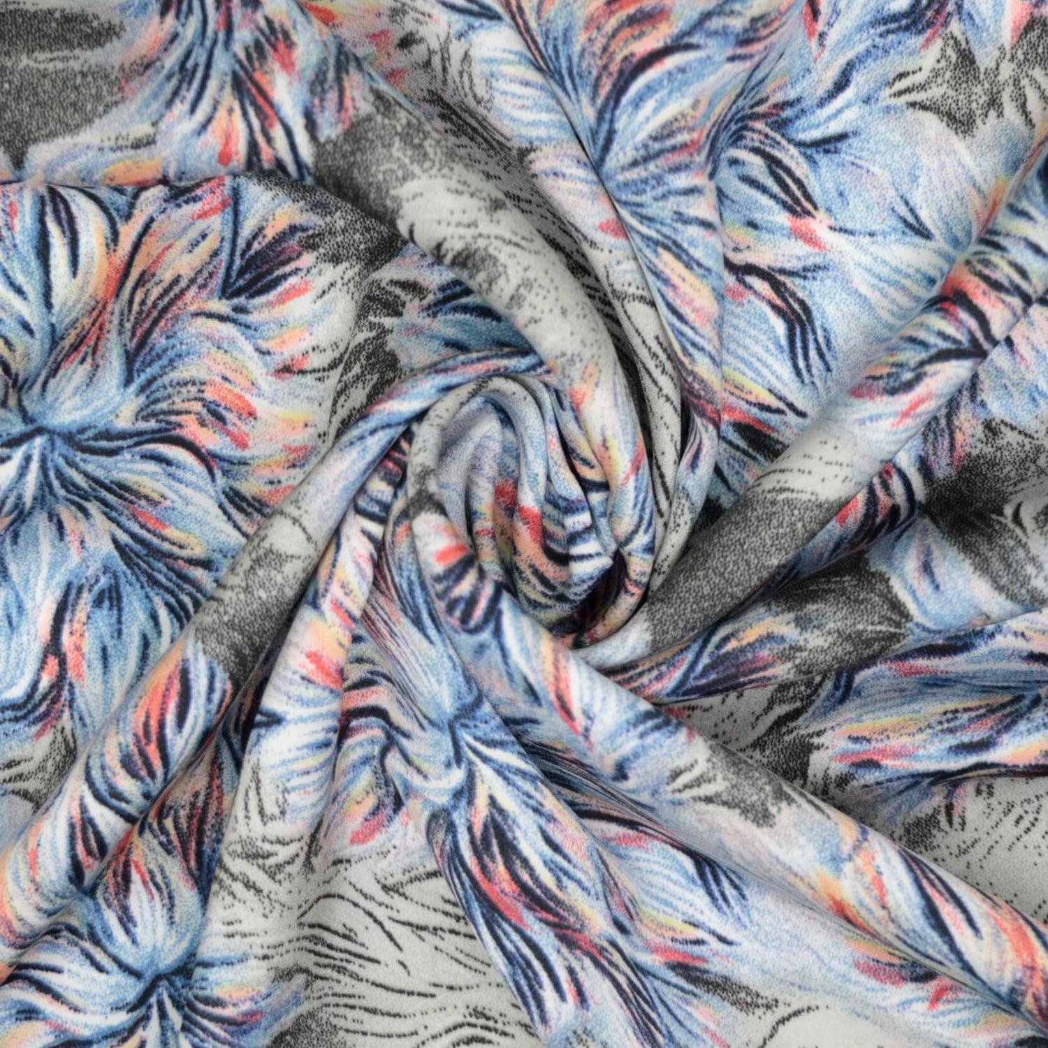 Close-up of fabric with abstract pattern in blue, pink, and gray.