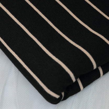 Black fabric with beige stripes on a white background