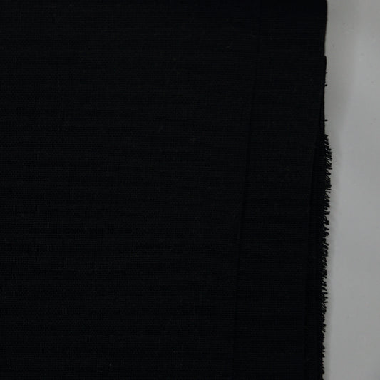 Black fabric with frayed edge on a white background