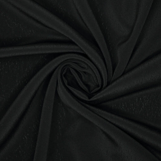 Close-up of black fabric with a swirl pattern