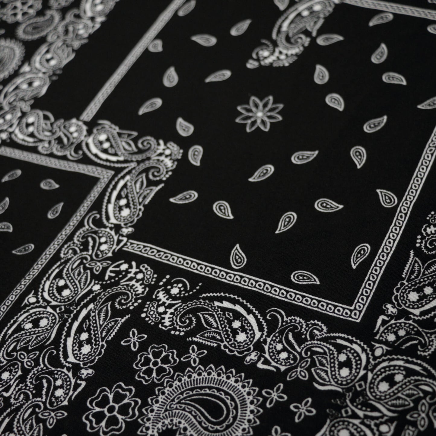 Black fabric with white paisley patterns