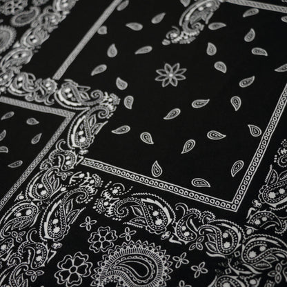Black fabric with white paisley patterns