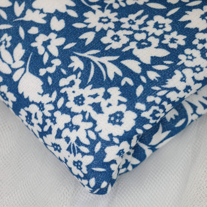 White floral patterned fabric on a Blue background