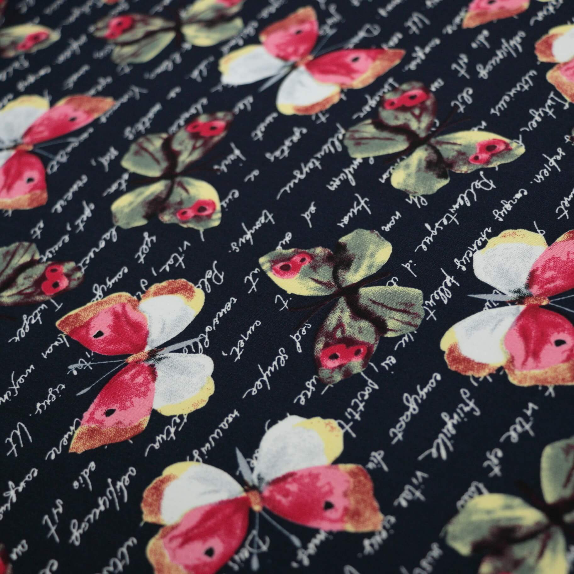 Butterfly pattern fabric with text on a Navy background