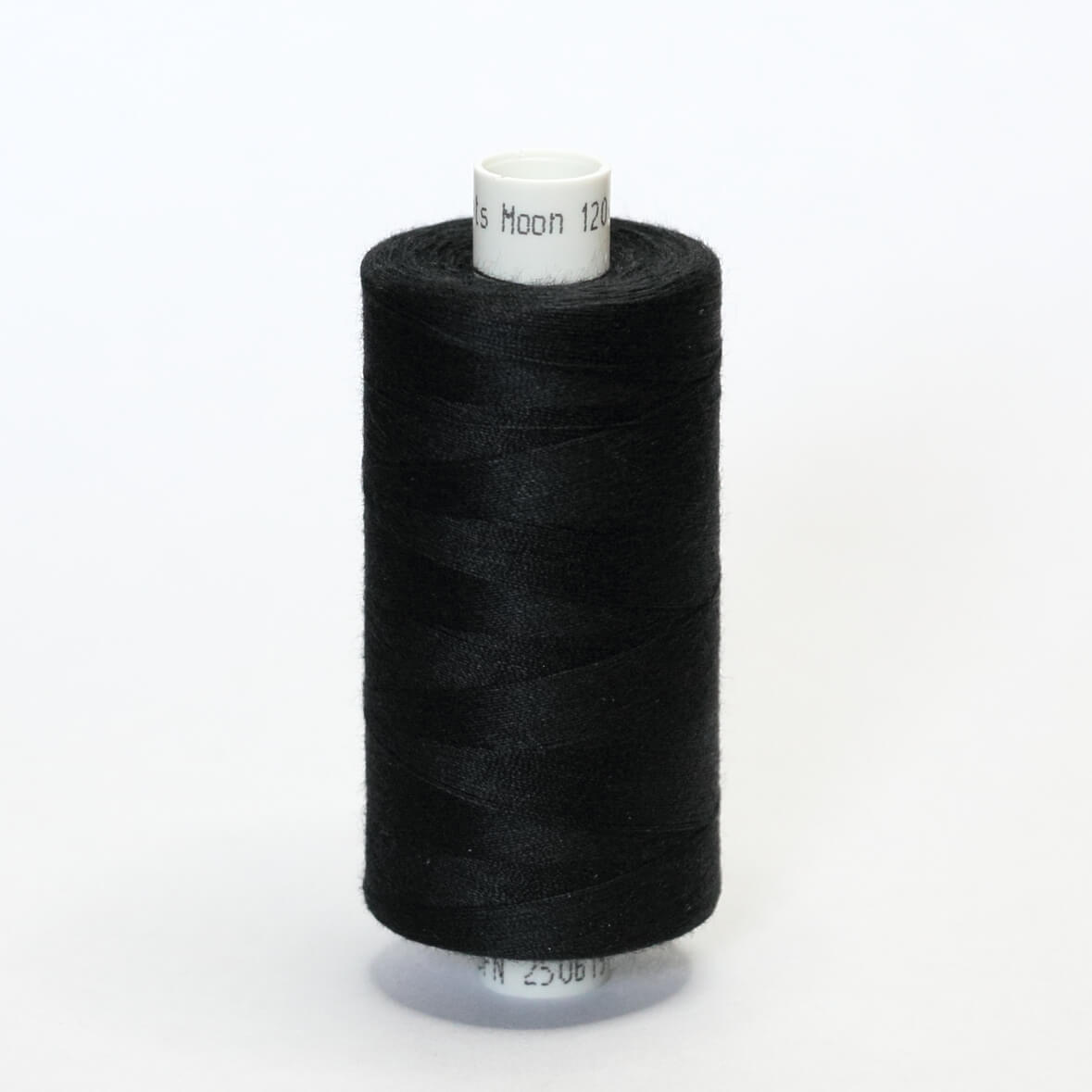 Spool of black thread on a white background