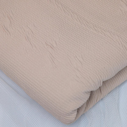 Beige textured fabric on a light gray background