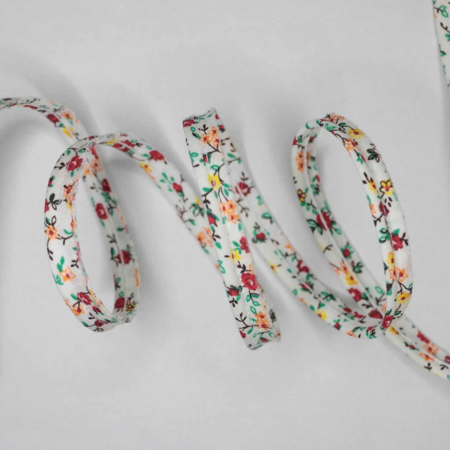 Floral-patterned shoelace on a light gray background