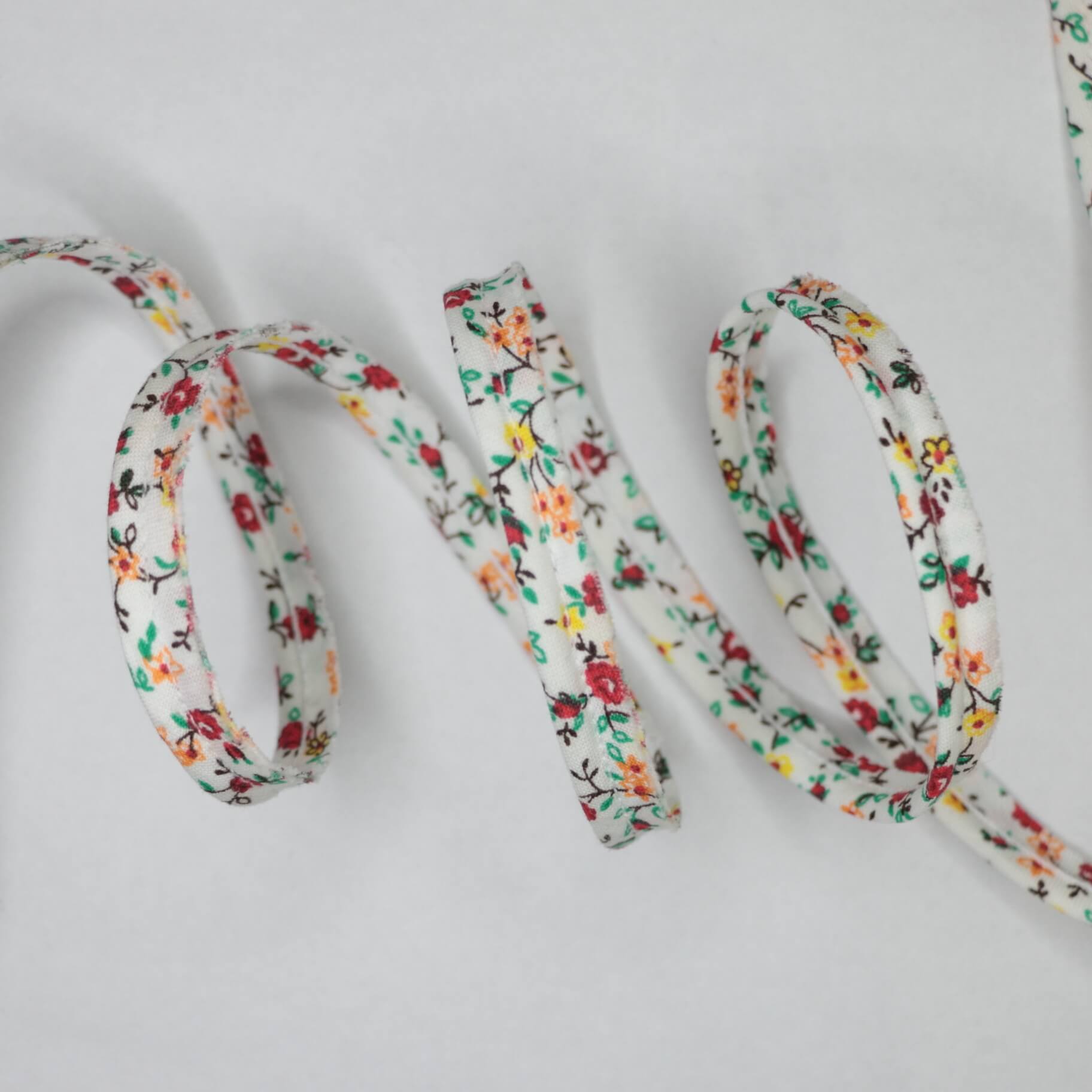 Floral-patterned shoelace on a light gray background