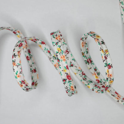 Floral-patterned shoelace on a light gray background