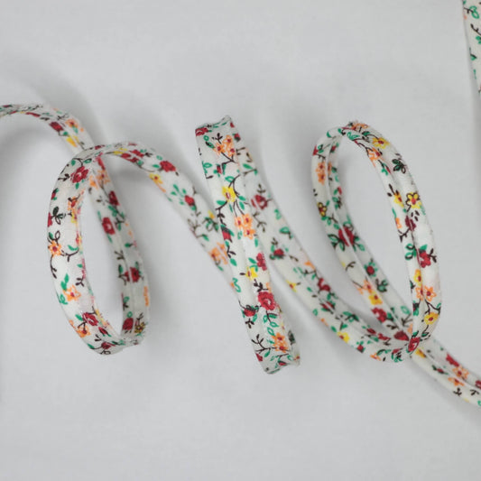 Floral-patterned shoelace on a light gray background