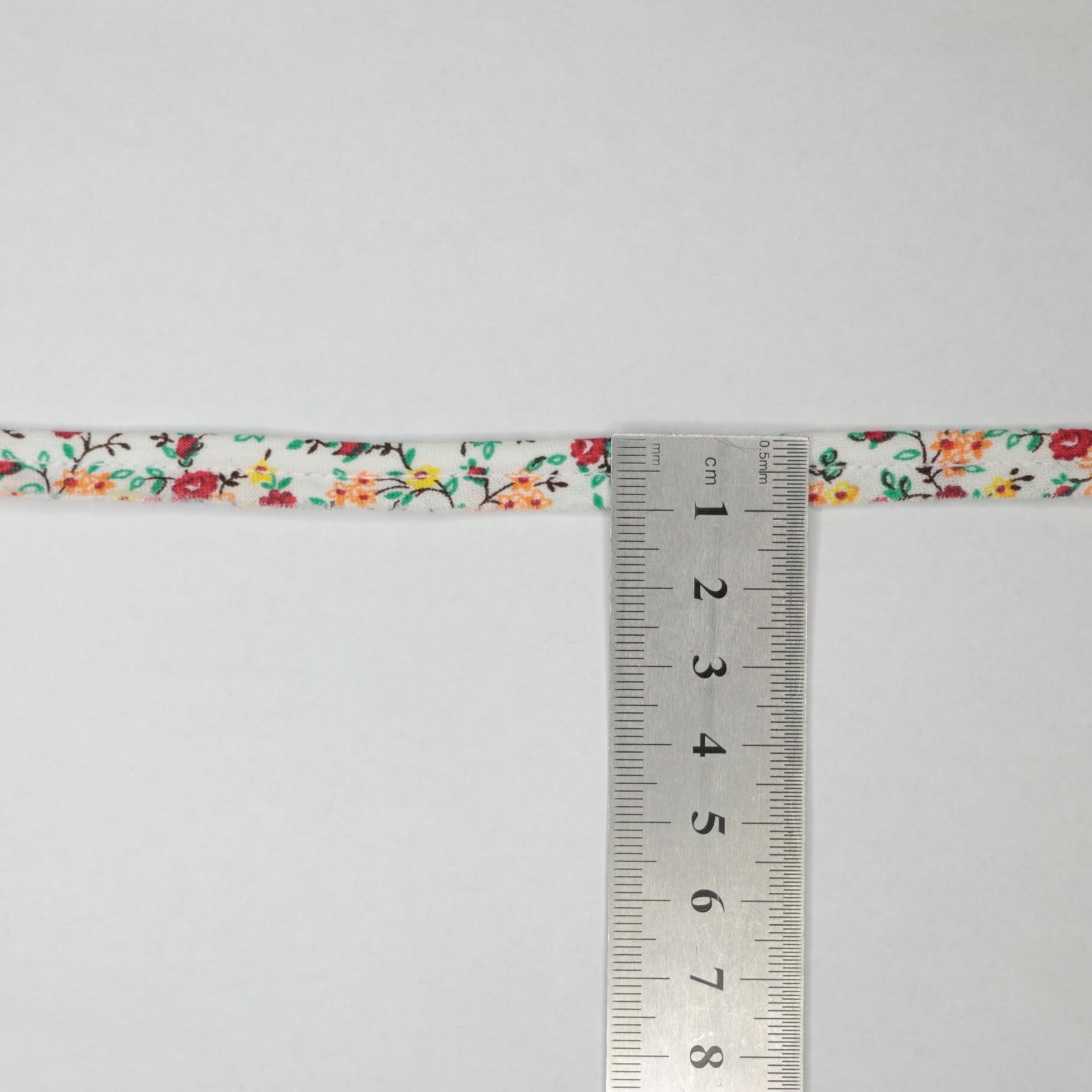 Floral ribbon with a ruler for measurement on a white background