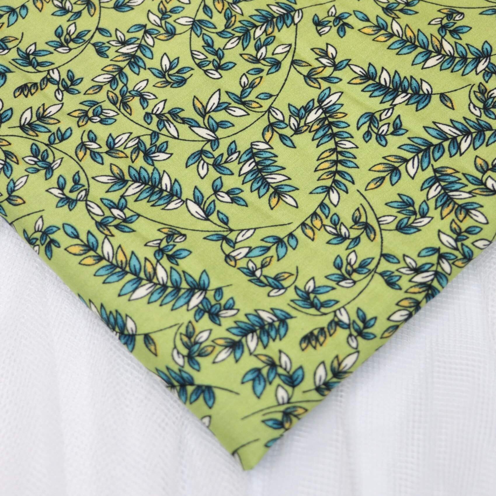 Fabric with green leaf pattern on a white background