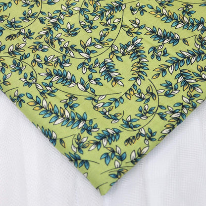 Fabric with green leaf pattern on a white background