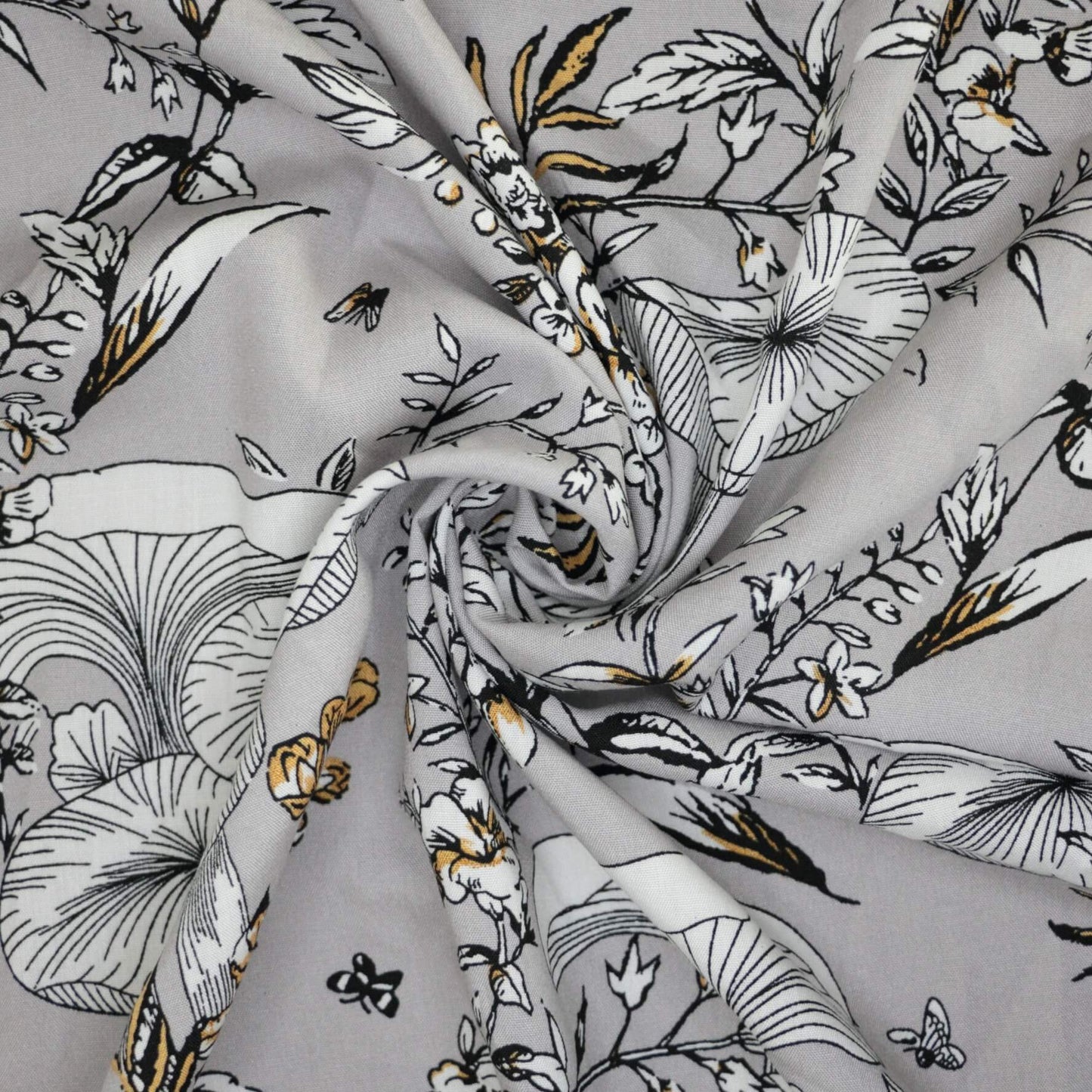 Floral fabric with black, white, and gold pattern on gray background