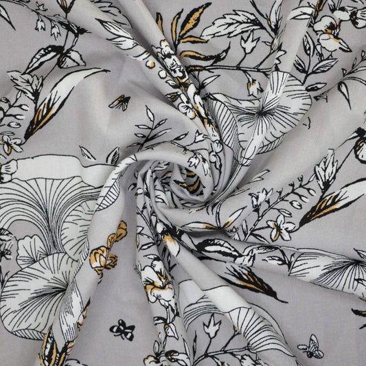 Floral fabric with black, white, and gold pattern on gray background