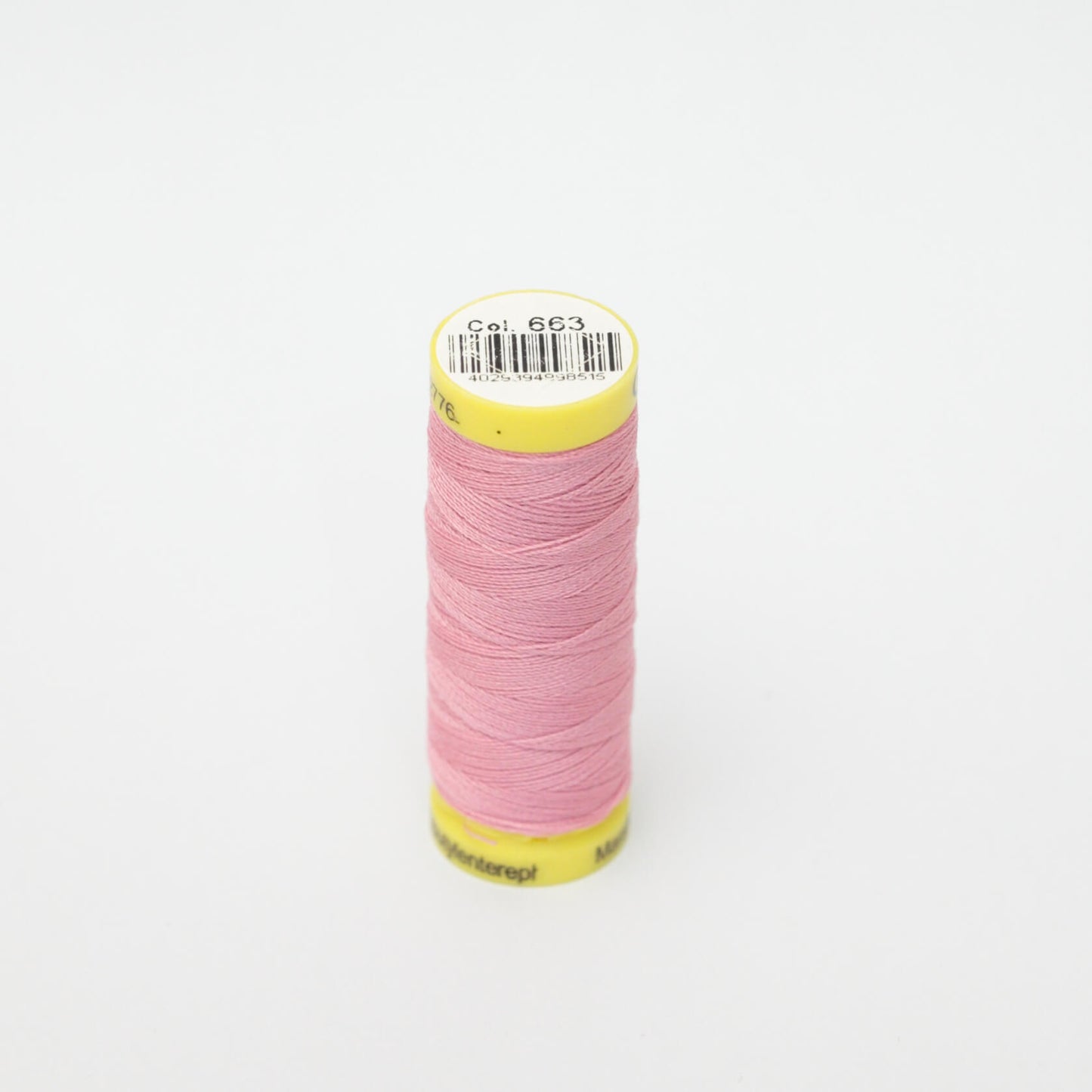 Spool of pink thread with a yellow label on a white background