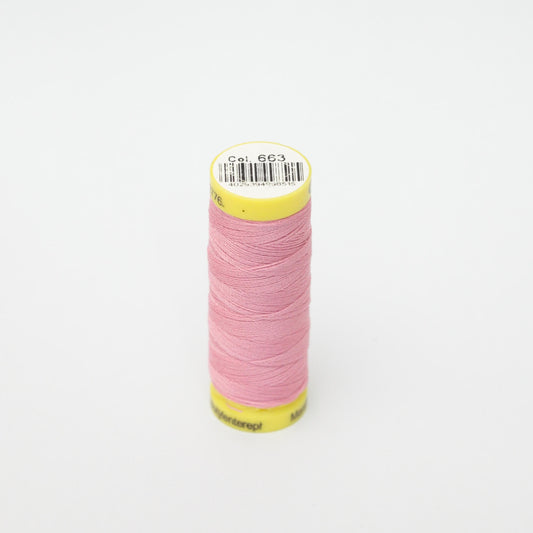 Spool of pink thread with a yellow label on a white background