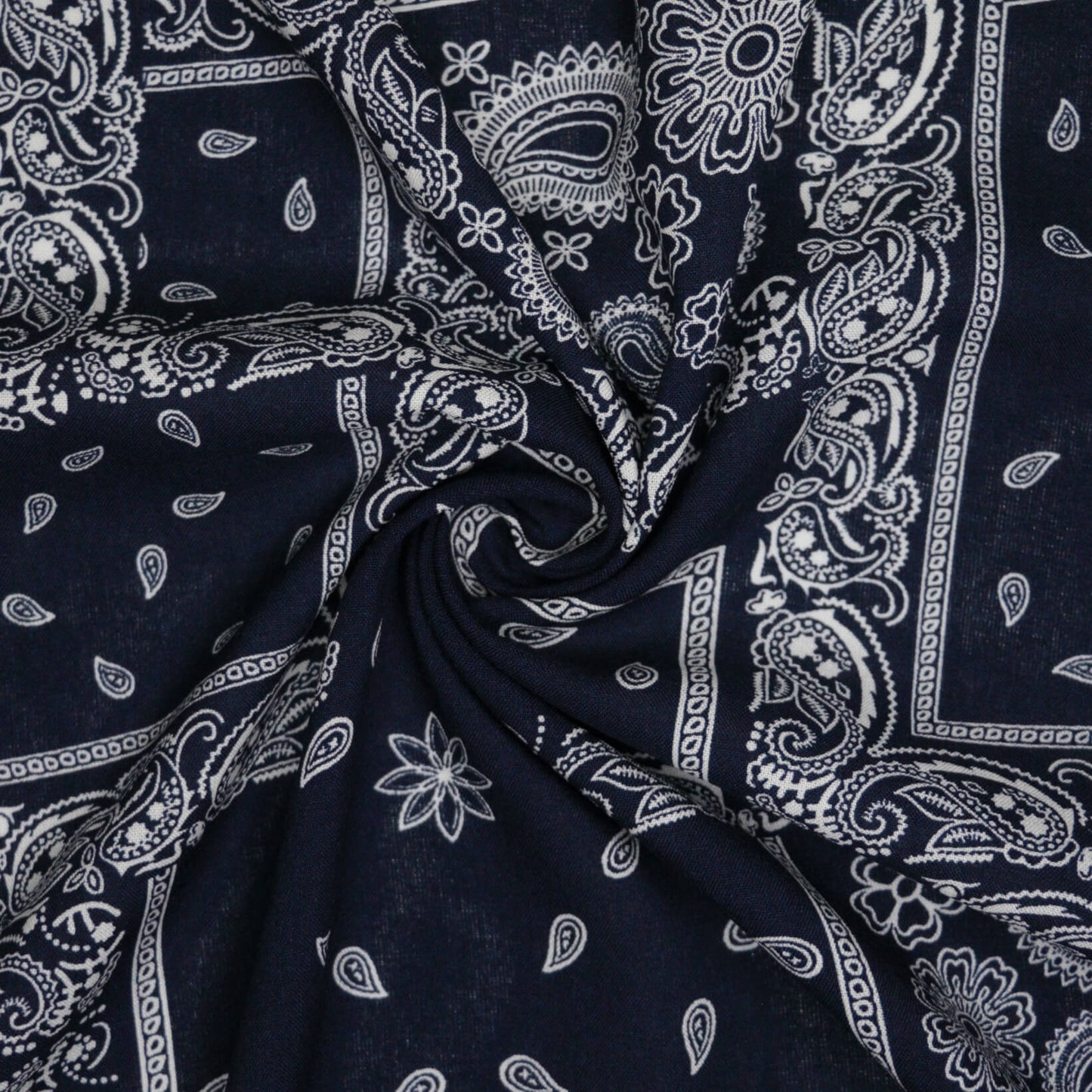 Navy blue fabric with white paisley patterns