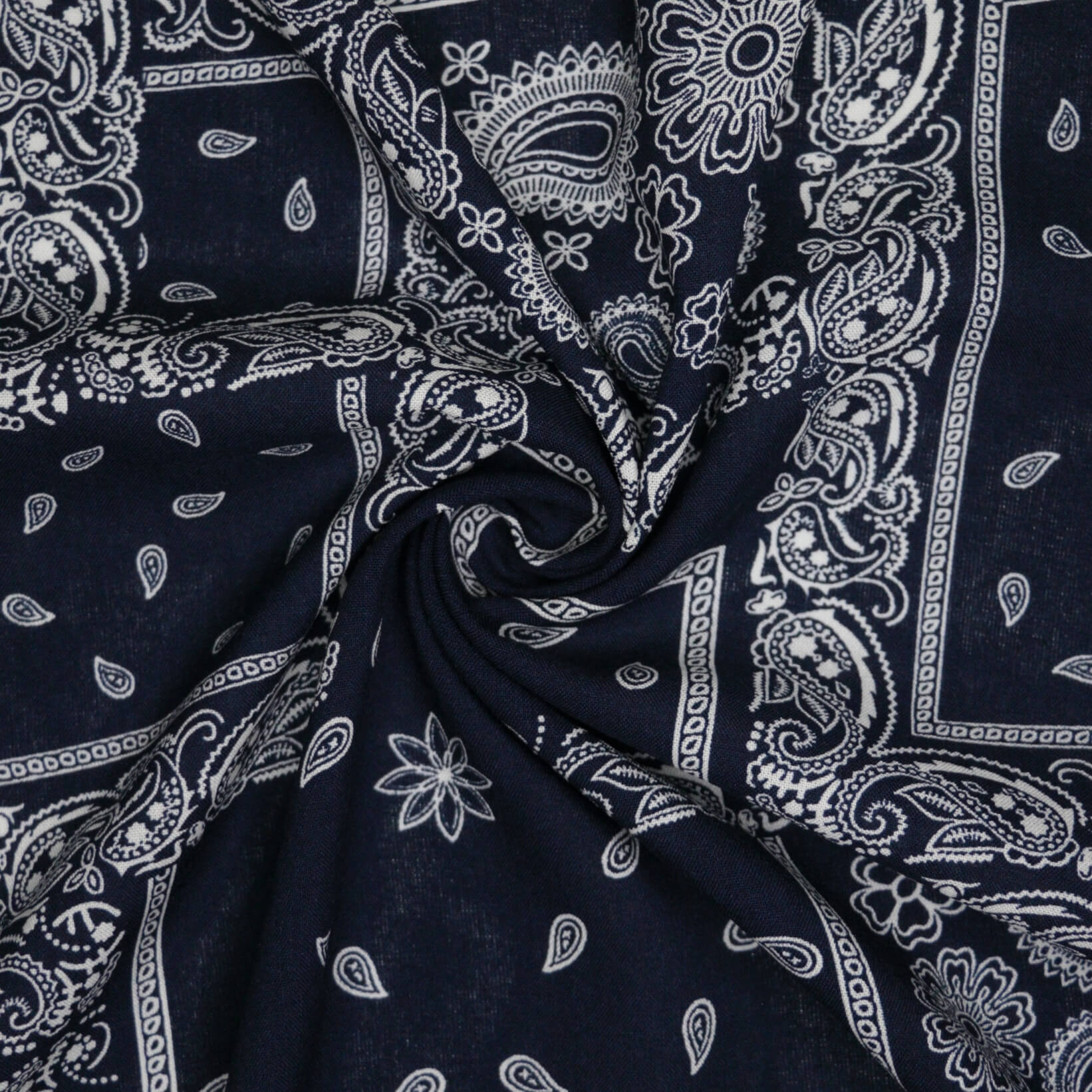Navy blue fabric with white paisley patterns