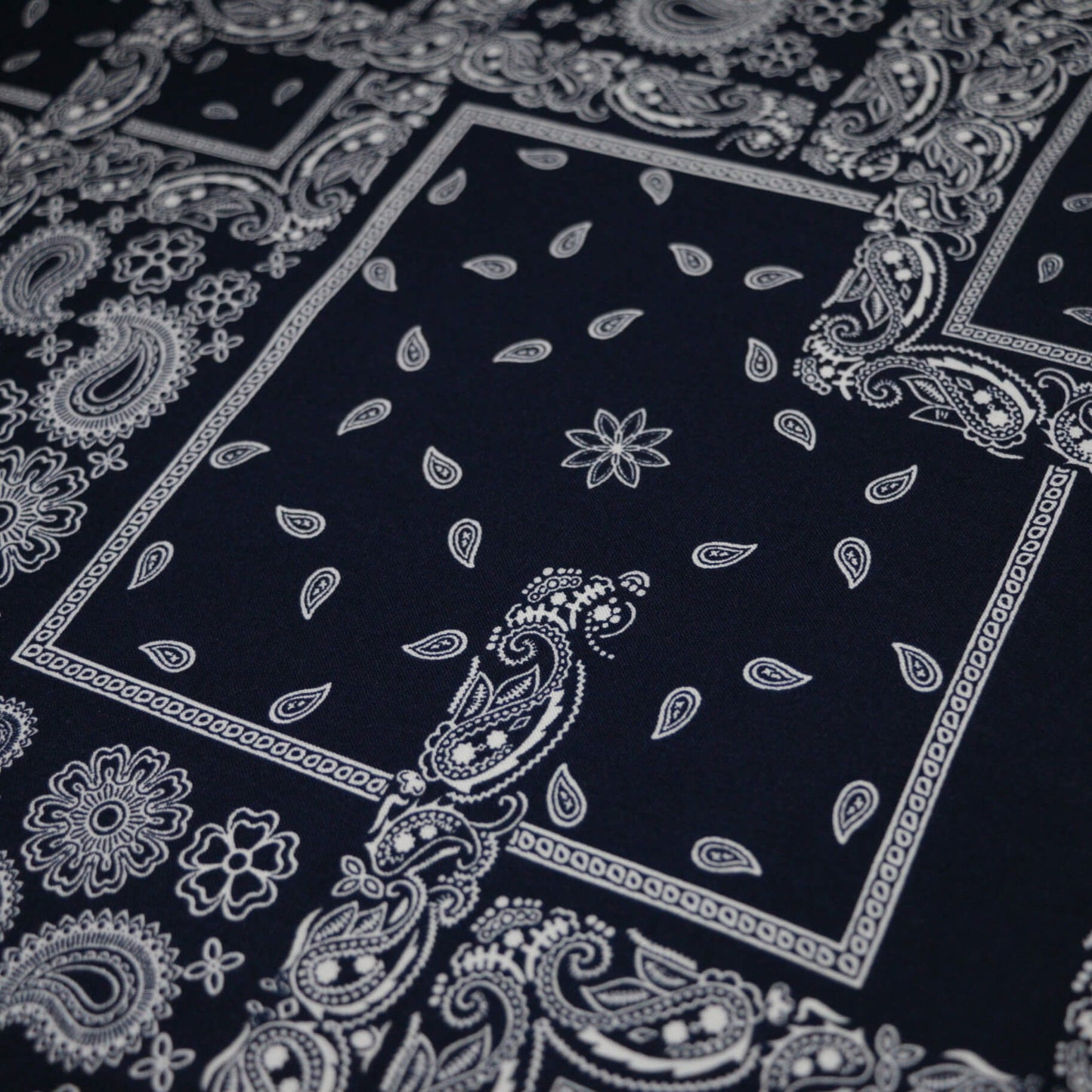 Black bandana with white paisley patterns