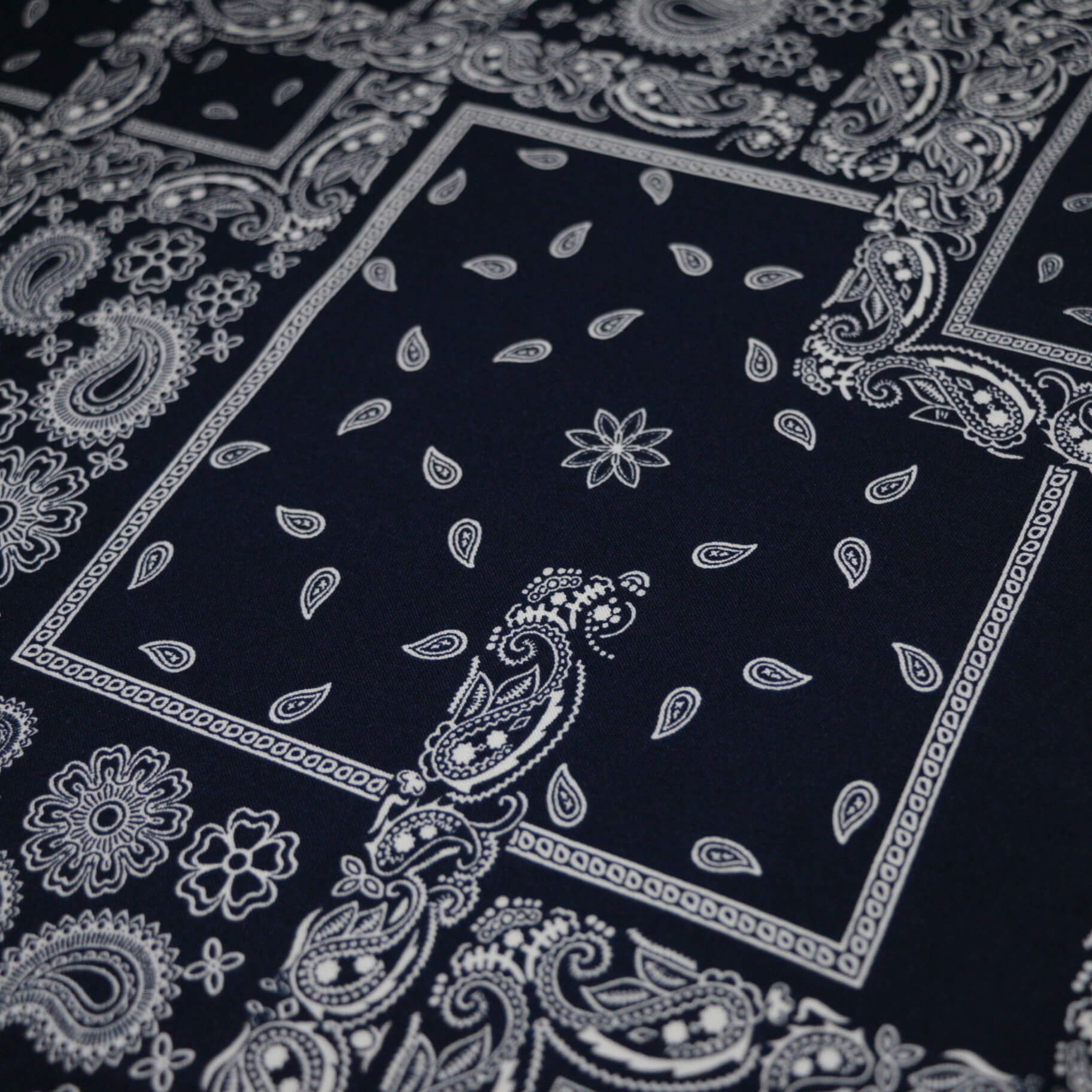 Black bandana with white paisley patterns