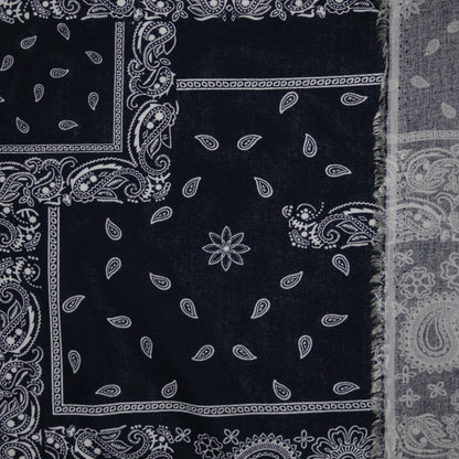 Black bandana with white paisley patterns on a plain background