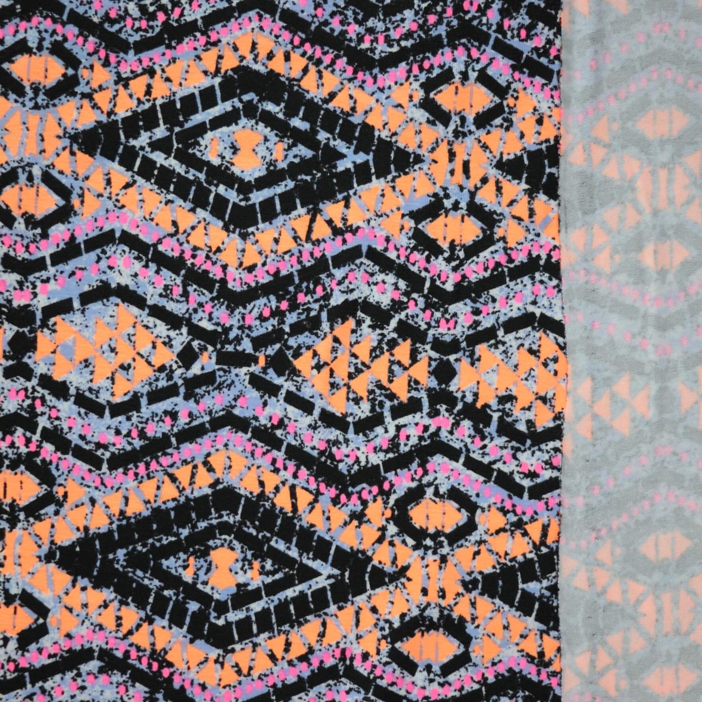 Patterned fabric with black, orange, and pink design on a gray background