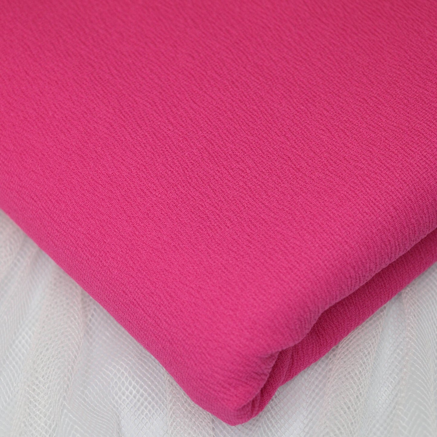 Pink fabric on a white background