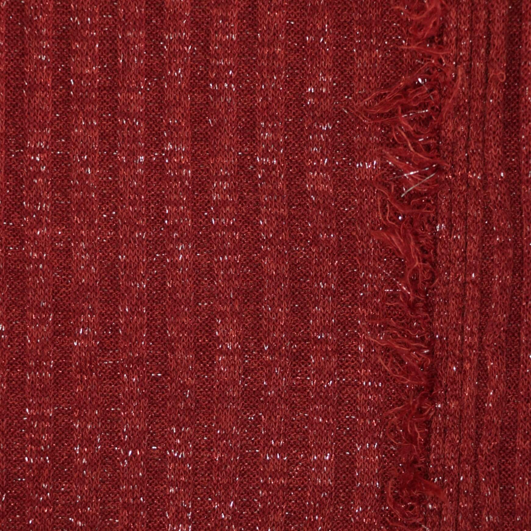 Close-up of red textured fabric with a frayed edge