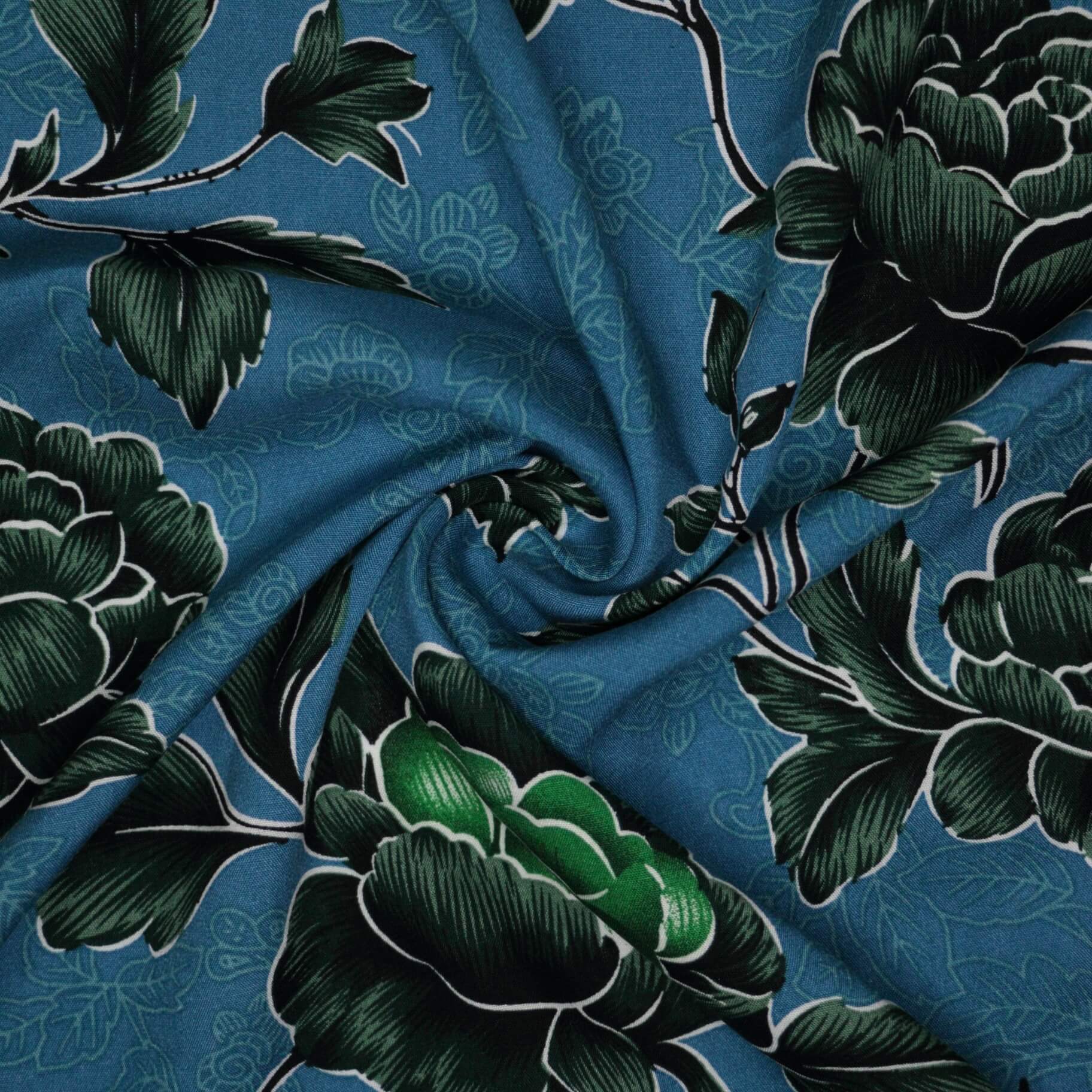 Floral fabric with green leaves on a blue background