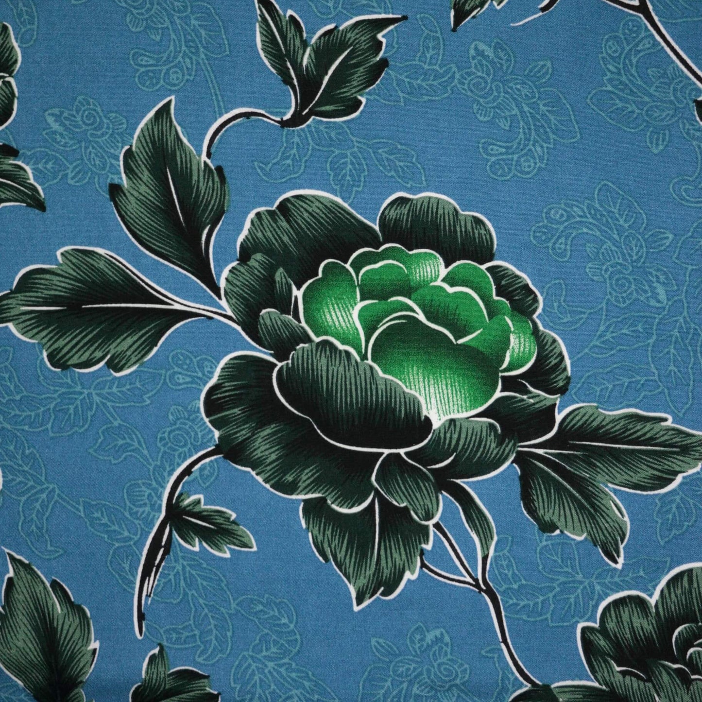 Green floral design on a blue background