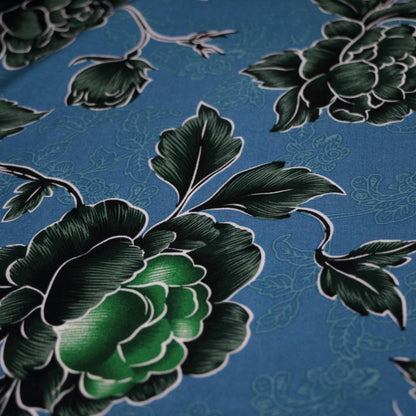 Close-up of green floral pattern on a blue background