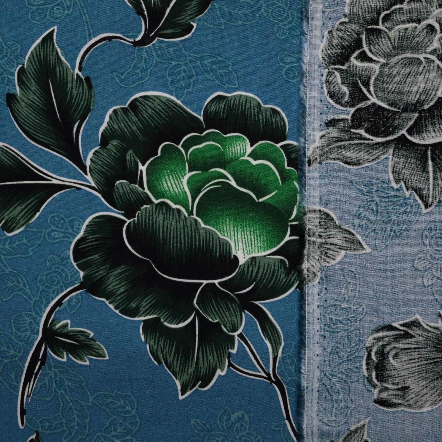 Close-up of floral patterns on fabric with green flowers.