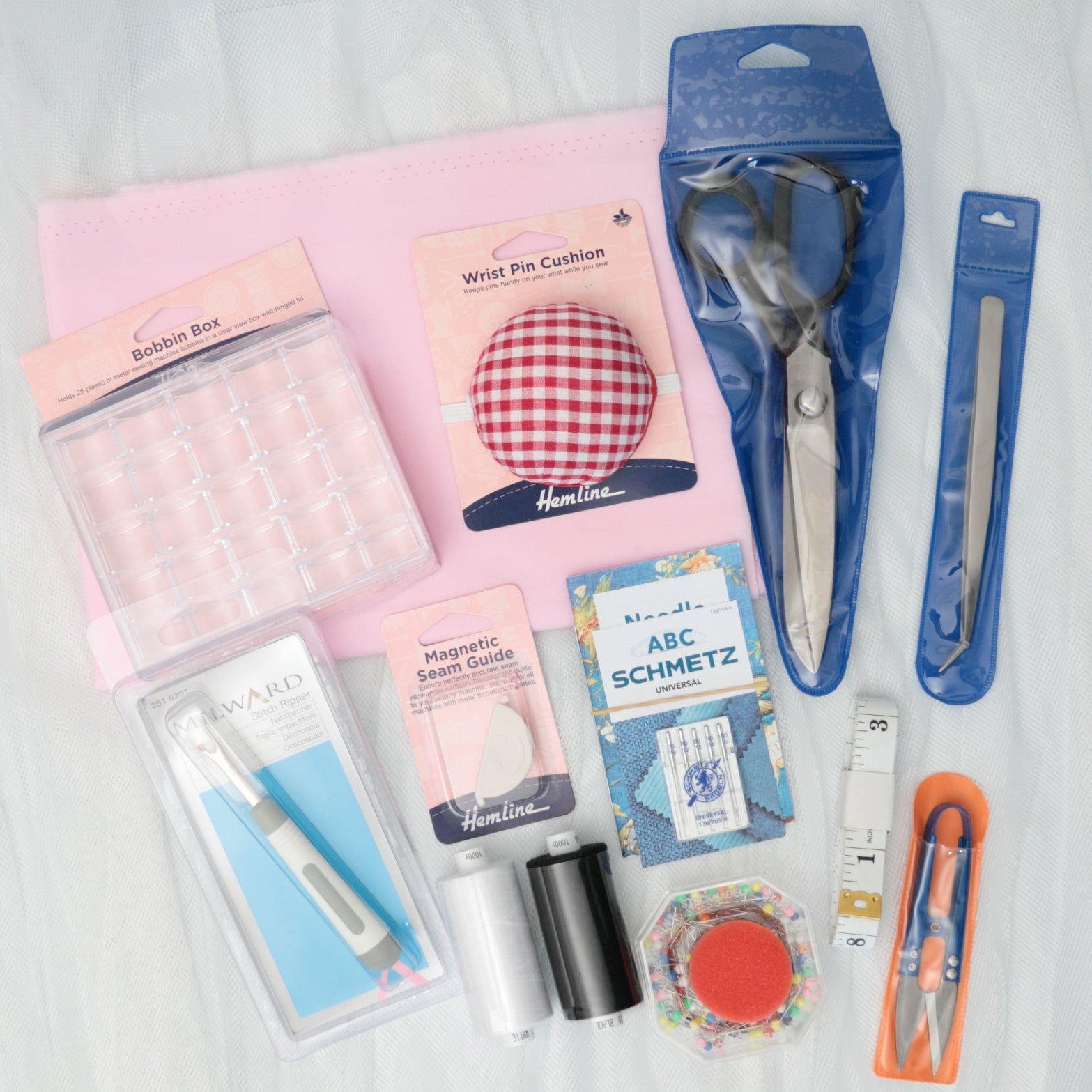 Collection of sewing tools and accessories on a white background